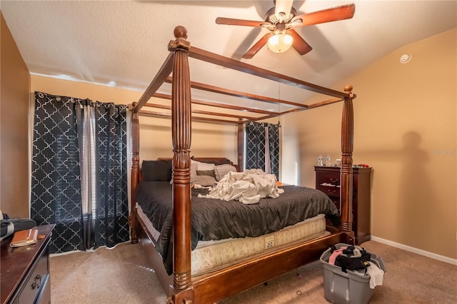 bedroom featuring vaulted ceiling, carpet flooring, ceiling fan, and a textured ceiling