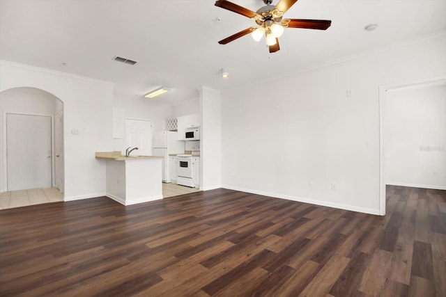 unfurnished living room featuring ceiling fan, dark hardwood / wood-style flooring, ornamental molding, and sink