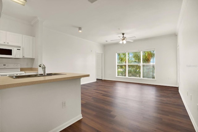 kitchen with white cabinets, dark hardwood / wood-style flooring, white appliances, and sink