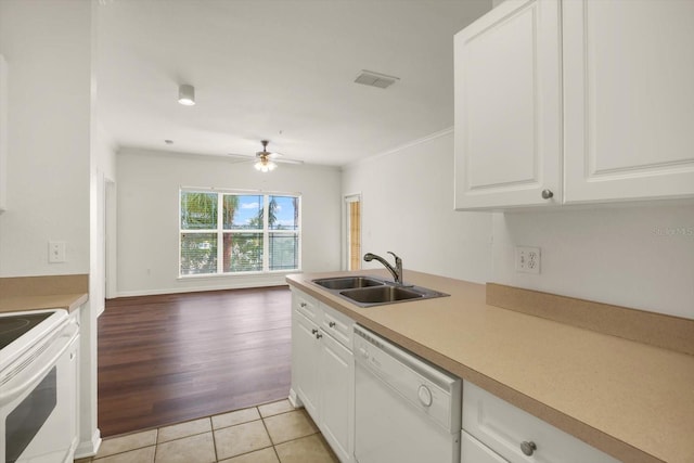 kitchen featuring white appliances, ceiling fan, sink, light hardwood / wood-style flooring, and white cabinetry