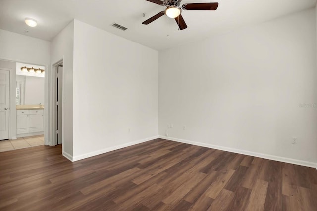 unfurnished room featuring ceiling fan and dark hardwood / wood-style flooring