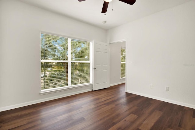 unfurnished room featuring ceiling fan and dark wood-type flooring