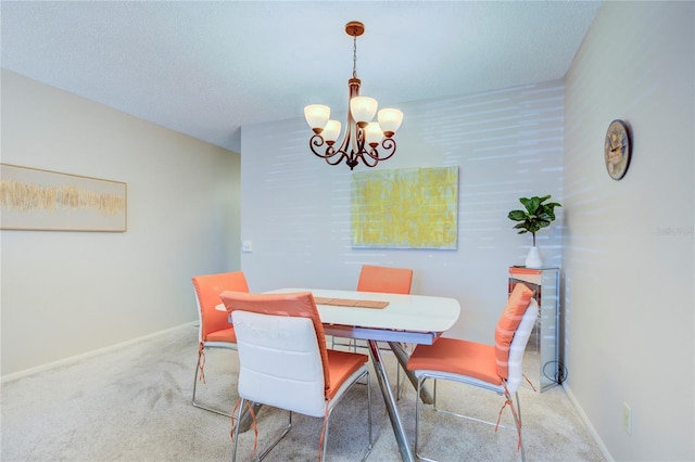 carpeted dining area featuring a chandelier