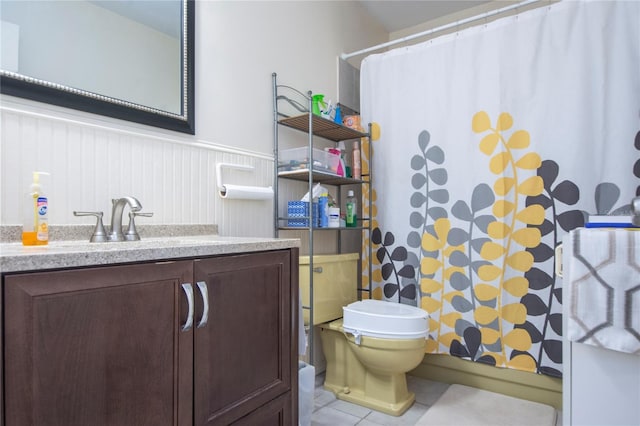 bathroom with toilet, a shower with curtain, vanity, and tile patterned floors