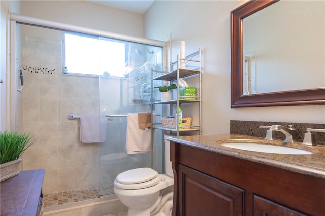 bathroom featuring tile patterned flooring, an enclosed shower, vanity, and toilet