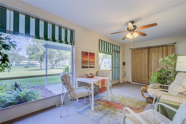 sunroom / solarium featuring ceiling fan