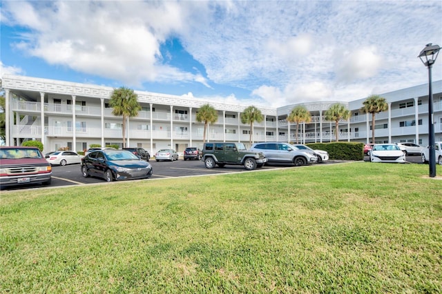 view of vehicle parking with a yard