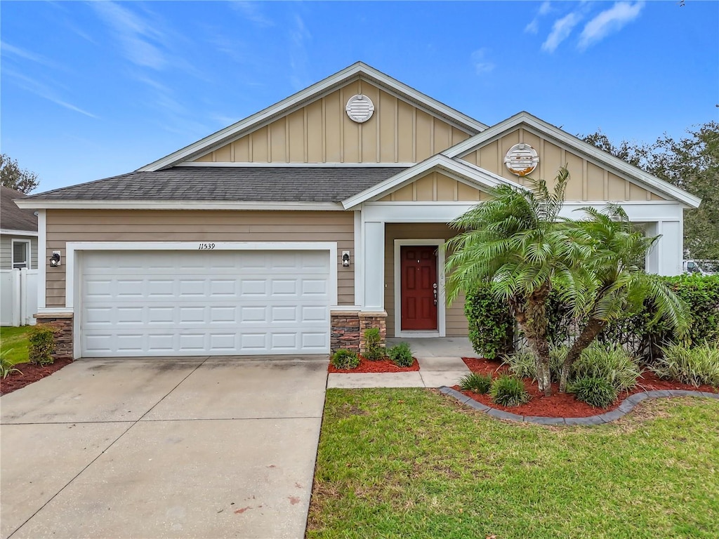 view of front of property with a garage and a front yard