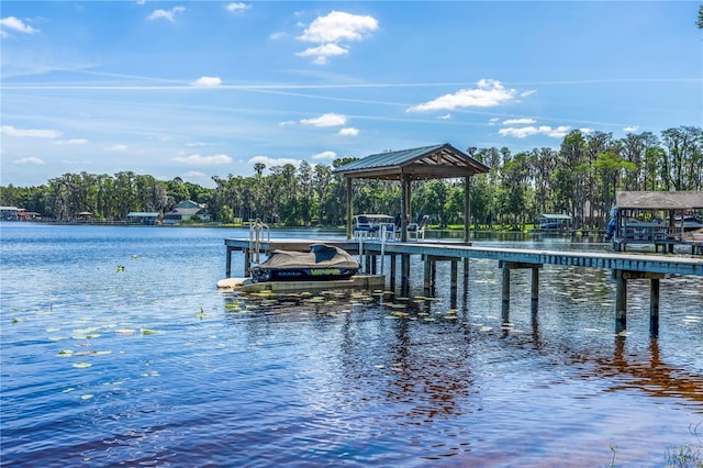 view of dock with a gazebo and a water view