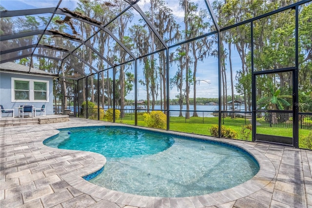 view of swimming pool featuring a water view, a patio, and glass enclosure