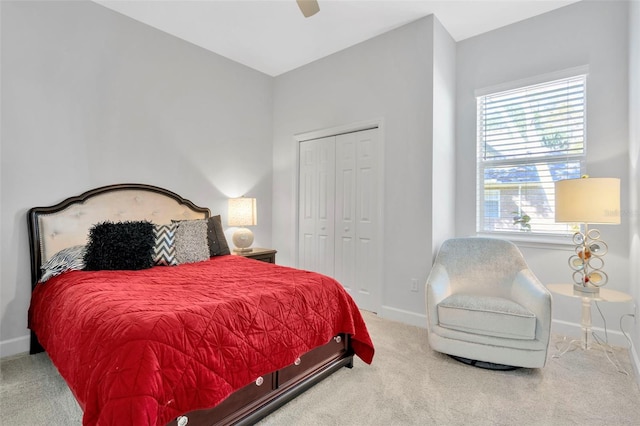 carpeted bedroom with ceiling fan and a closet