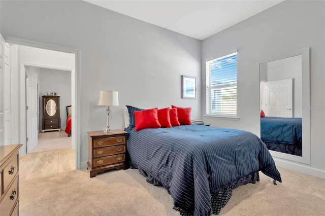 bedroom featuring light carpet