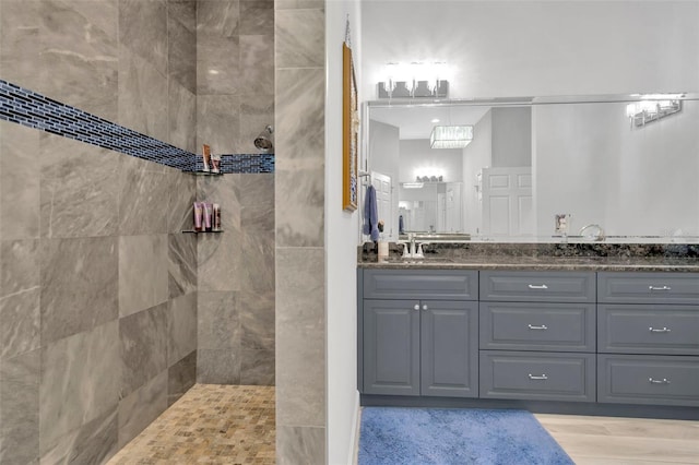 bathroom featuring vanity and a tile shower