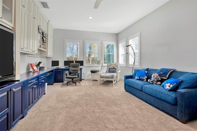 carpeted office featuring ceiling fan