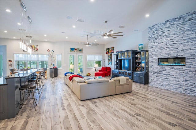 living room featuring light hardwood / wood-style floors, french doors, and ceiling fan