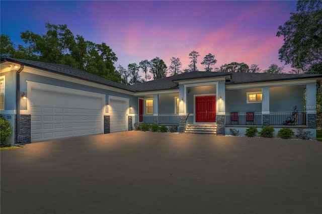 view of front of house featuring a garage, concrete driveway, a porch, and stucco siding