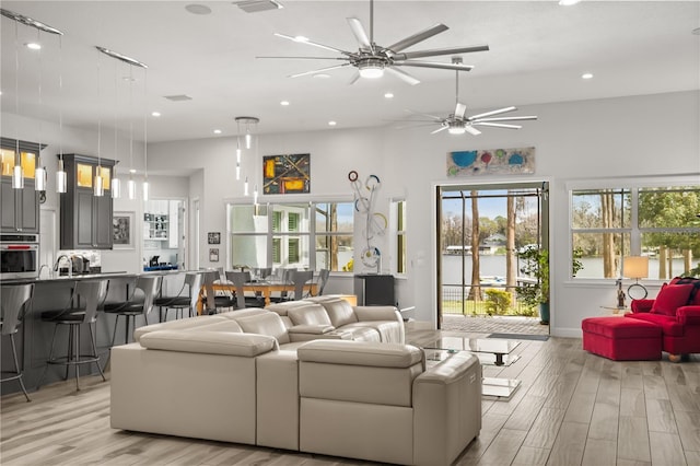 living area with recessed lighting, a healthy amount of sunlight, and light wood-style flooring