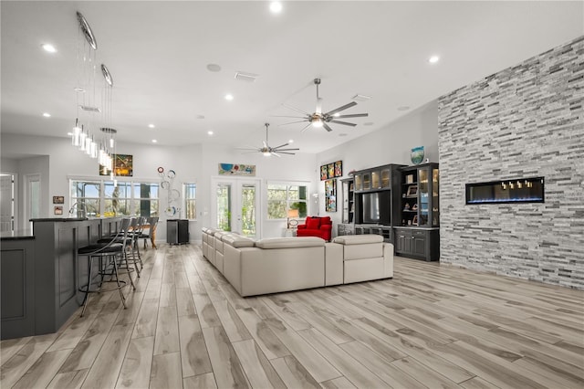 living room featuring ceiling fan, recessed lighting, and light wood-style floors