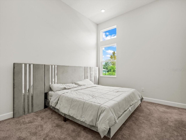 bedroom featuring carpet floors and vaulted ceiling