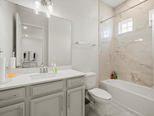 full bathroom with vanity, toilet, and tiled shower / bath