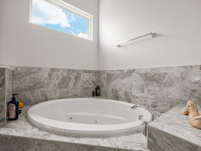 bathroom with a relaxing tiled tub