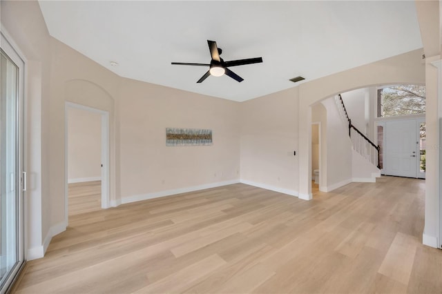 unfurnished living room featuring ceiling fan and light wood-type flooring