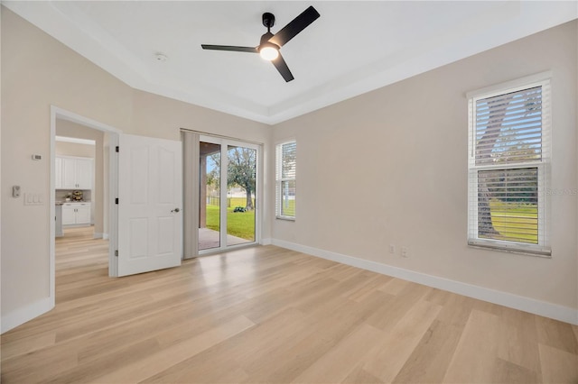 empty room with light hardwood / wood-style floors and ceiling fan