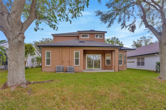 back of property featuring central AC unit, a patio, and a yard