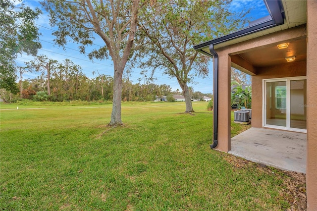 view of yard featuring a patio and central AC