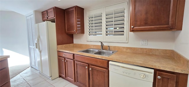 kitchen with sink, white appliances, and light tile patterned floors