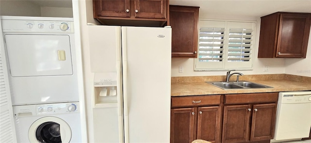 laundry room featuring stacked washer and clothes dryer and sink