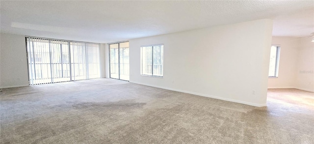 carpeted empty room with a textured ceiling and ceiling fan