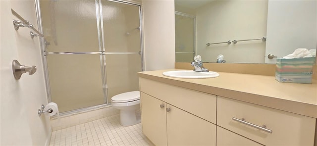 bathroom featuring tile patterned flooring, vanity, toilet, and a shower with shower door