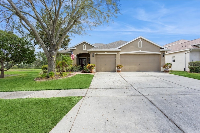 1433 Emerald Hill Way, Valrico, FL 33594 - ranch-style house with stucco siding, a garage, driveway, and a front lawn