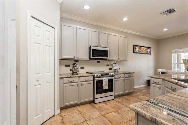 kitchen with decorative backsplash, light stone countertops, gray cabinetry, stainless steel appliances, and crown molding