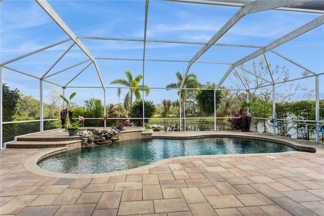 view of swimming pool featuring a patio and glass enclosure