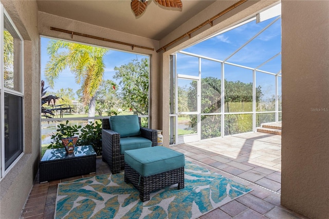 sunroom / solarium featuring ceiling fan