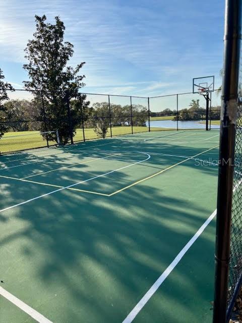 view of sport court with a water view