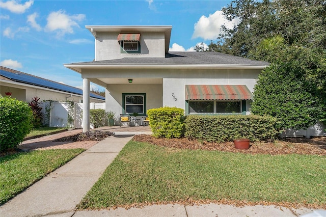 view of front of house with a patio area and a front lawn