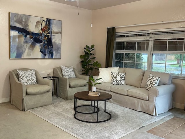 living room featuring carpet and baseboards