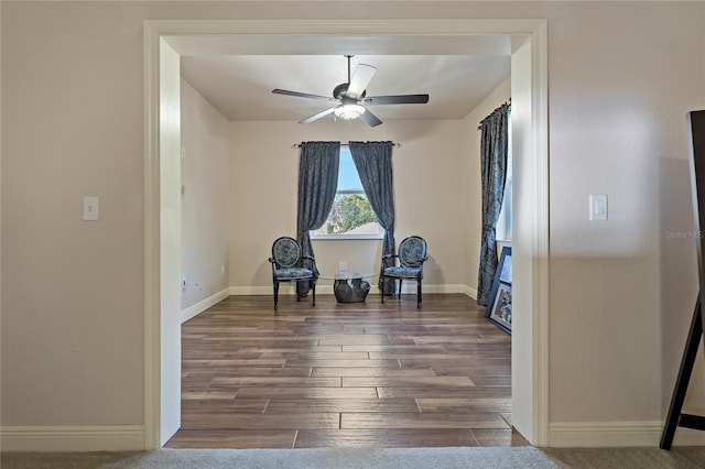 living area with ceiling fan, wood finished floors, and baseboards