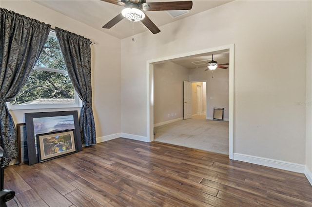 unfurnished living room with wood finished floors and baseboards