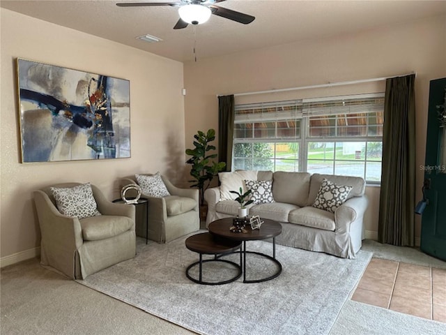 tiled living area with a ceiling fan, baseboards, visible vents, and carpet flooring