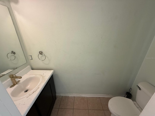 bathroom featuring toilet, tile patterned floors, and vanity