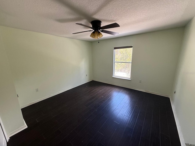 empty room featuring a textured ceiling, ceiling fan, and dark hardwood / wood-style floors