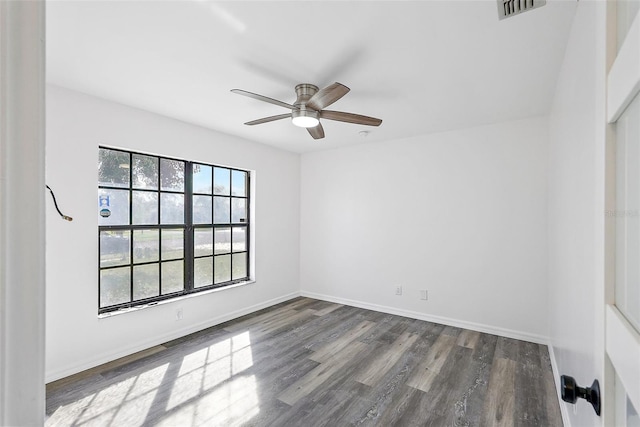 empty room with dark hardwood / wood-style floors and ceiling fan