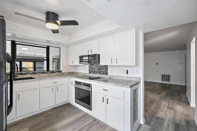 kitchen with dark wood-type flooring, white cabinetry, sink, and black appliances