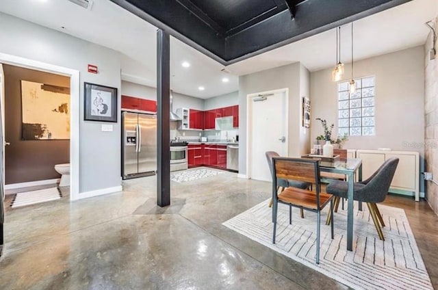 dining room with finished concrete flooring, recessed lighting, and baseboards