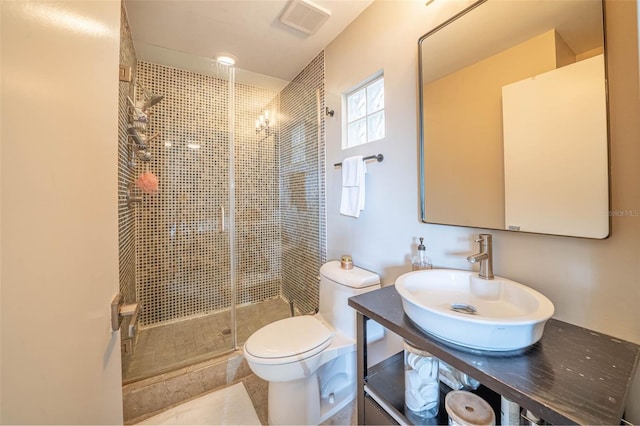 full bathroom with toilet, a stall shower, visible vents, and a sink