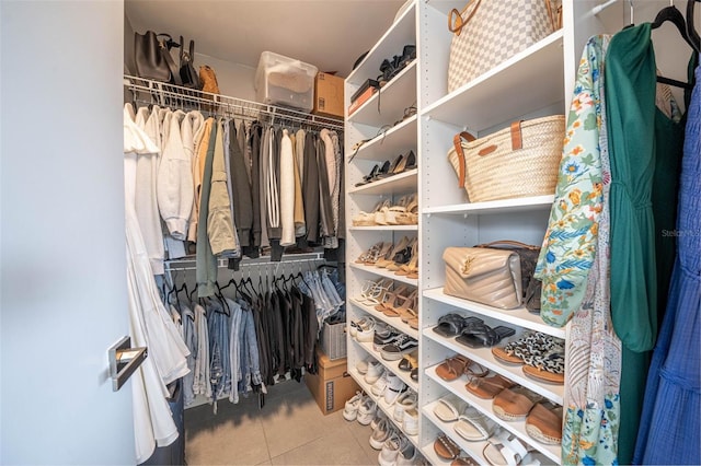 walk in closet with tile patterned flooring